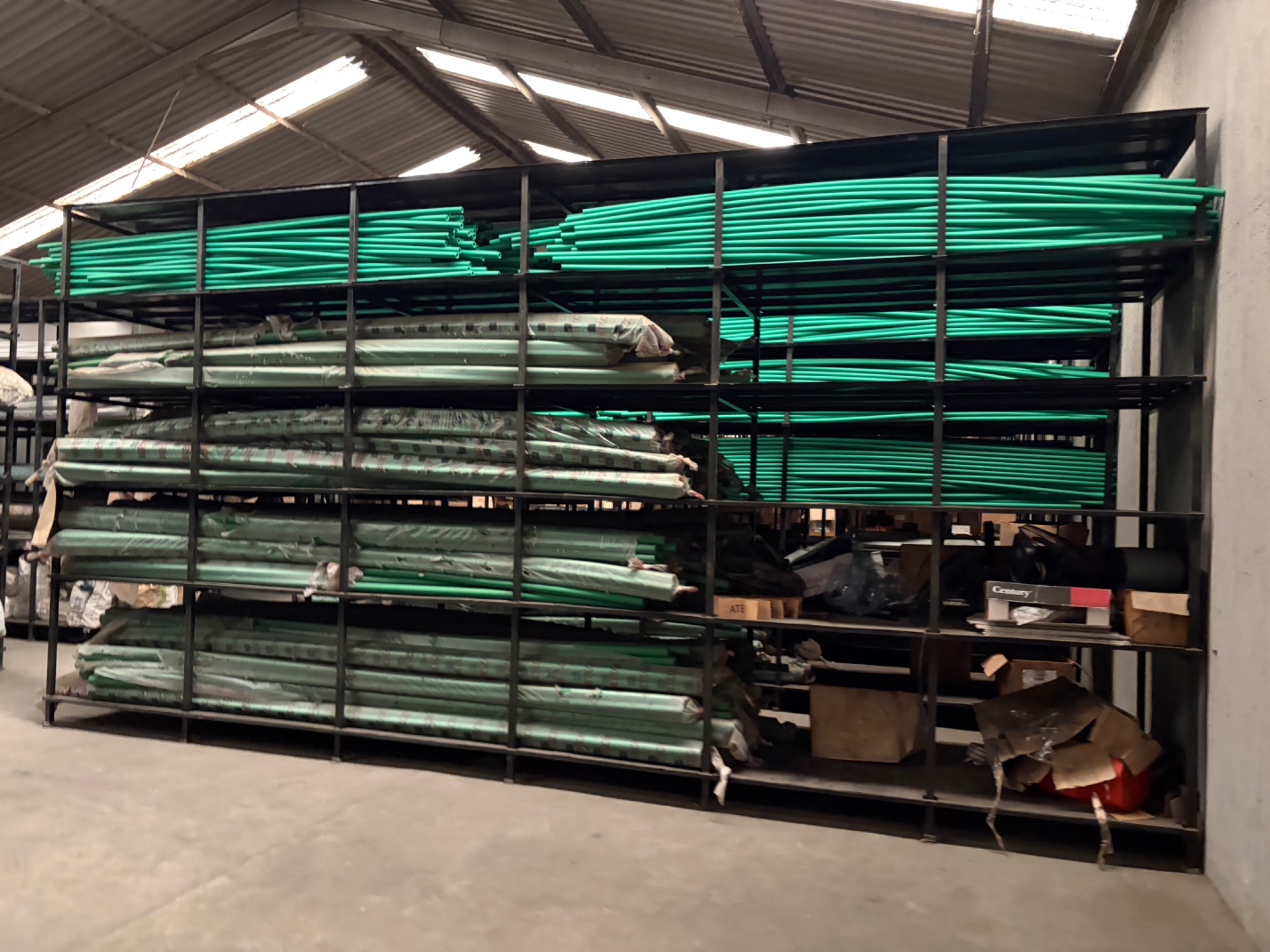 PPR pipes arranged on warehouse storage racks, photograph 1